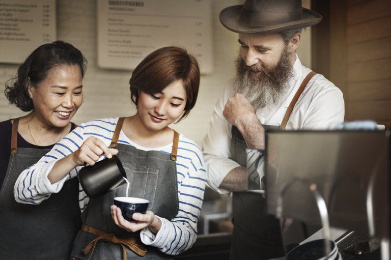 Coffee shop franchisee owner pouring coffee